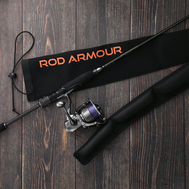Spinning rod beside Rod Armour Pro sleeve on dark wood floor lifestyle shot