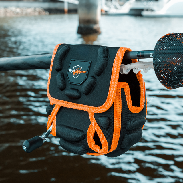 Spinning Reel Cover hanging on a rod over harbour water in evening light