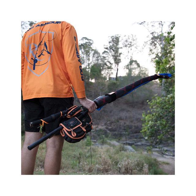 Angler carrying fishing rods with Rod Armour spinning reel covers protecting reels